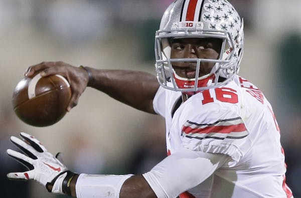 Ohio State quarterback J.T. Barrett looks to pass during the first half of an NCAA college football game against Michigan State in East Lansing, Mich.