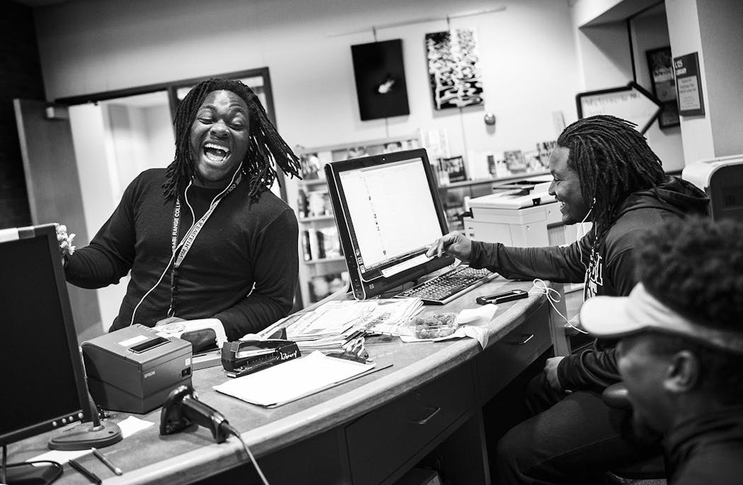 Teammates Elvin Turner, left, laughed while talking about girls with Kalil Grice and Benjamin Allen in the library of Mesabi Range College. As part of work study, the three work as library aides during the school year.