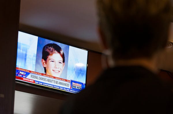 Chandra Holmen, a supervisor at American Burger Bar in St. Joseph watches a press conference revealing a new "person of interest" in the Jacob Wetterl