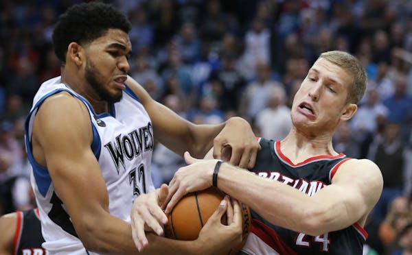 Wolves rookie Karl-Anthony Towns (shown battling with Trail Blazer Mason Plumlee) is winning fans over.
