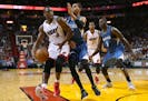 The Miami Heat's Dwyane Wade, left, drives against the Minnesota Timberwolves' Kevin Martin, during the second quarter at the AmericanAirlines Arena i