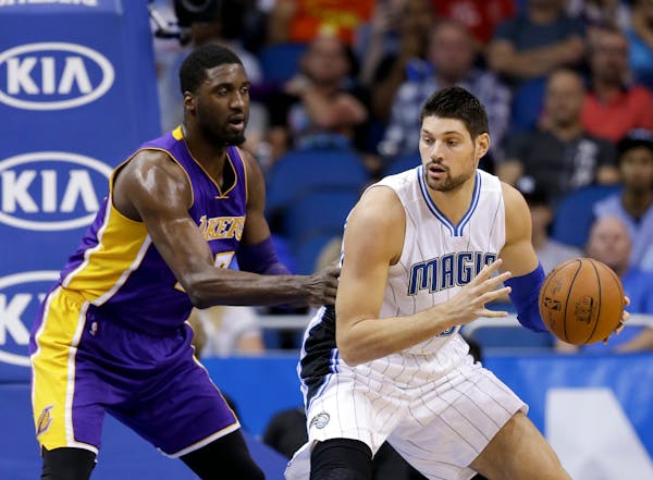 Magic center Nikola Vucevic, right, is one of only two players who has averaged 10 rebounds in each of the past three seasons.