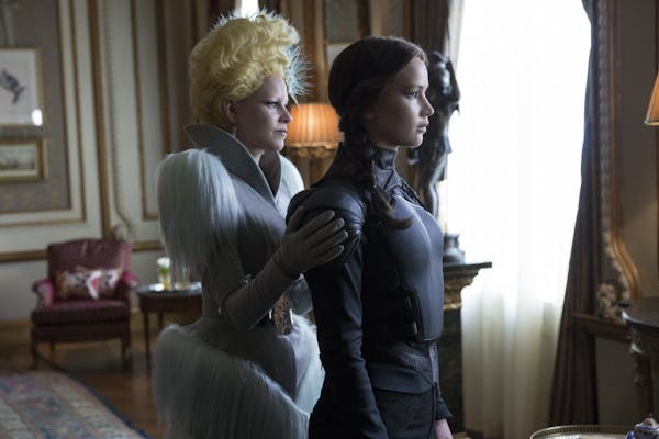 Elizabeth Banks as Effie Trinket, left, and Jennifer Lawrence as Katniss Everdeen in a scene from "The Hunger Games: Mockingjay Part 2."