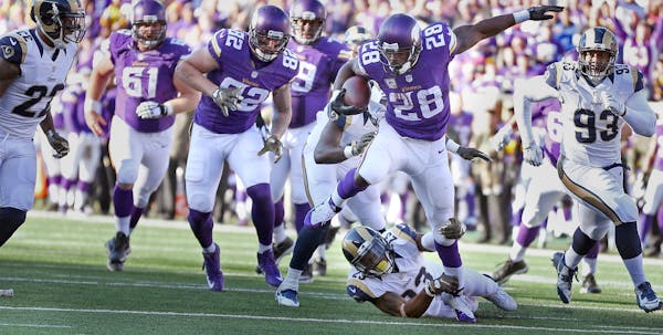 Minnesota Vikings running back Adrian Peterson (28) high stepped over St. Louis Rams free safety Rodney McLeod (23) in the forth quarter Sunday Novemb