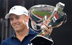 Jordan Spieth is presented the FedEx Cup after winning the Tour Championship golf tournament at East Lake Golf Club on Sunday, Sept. 27, 2015, in Atla