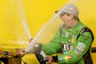Kyle Busch celebrated after winning the NASCAR Sprint Cup Series race and season title Sunday at Homestead-Miami Speedway in Homestead, Fla.