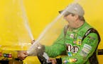 Kyle Busch celebrated after winning the NASCAR Sprint Cup Series race and season title Sunday at Homestead-Miami Speedway in Homestead, Fla.