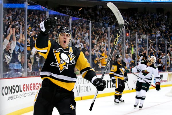 The Penguins' Evgeni Malkin celebrated his goal in the second period of a 4-3 victory over the Wild in Pittsburgh on Tuesday. Malkin had a hand in all