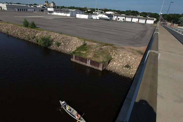 The view from the Plymouth Avenue Bridge of a former lumberyard purchased by the Minneapolis Park system. The site of a future riverfront park contain
