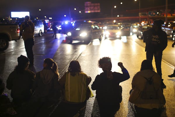 Protesters shut down the northbound lanes of Interstate 94 south of Broadway on Monday night where they linked arms and blocked traffic lanes for more