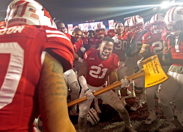 Wisconsin's cornerback Peniel Jean (21) took Paul Bunyan's Axe to the visiting goalpost after Wisconsin beat the Gophers last year in Madison.