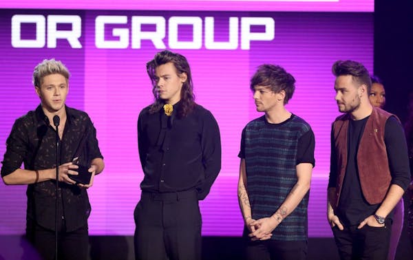 Niall Horan, from left, Harry Styles, Louis Tomlinson, and Liam Payne of One Direction, accept the award for favorite duo or group - pop/rock at the A