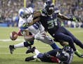 Seattle Seahawks strong safety Kam Chancellor (31) knocks the ball loose from Detroit Lions wide receiver Calvin Johnson (81) in the second half of an