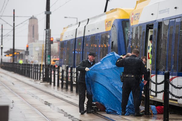 Metro Transit Police and other authorities investigate a fatality on the Green Line train tracks near Hamline Avenue in St. Paul on Thursday, December