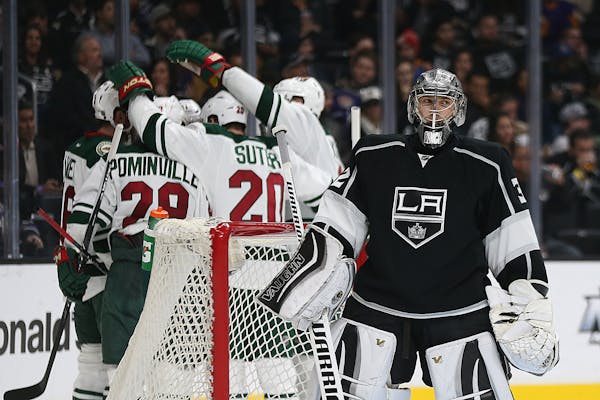Minnesota Wild players celebrate after Zach Parise scored a second-period goal against Los Angeles Kings goalie Jonathan Quick at Staples Center in Lo