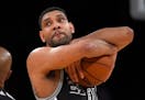 San Antonio Spurs center Tim Duncan hugs the ball prior to the Spurs' NBA basketball game against the Los Angeles Lakers, Friday, Jan. 22, 2016, in Lo