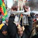 Ismael Omisaye an other Oromos joined hundreds of people who braved sub-zero temps as the marched during Martin Luther King, Jr. Holiday celebration M