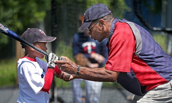 Jayden Moore, 7, listened to what Hall of Famer Rod Carew had to teach him during a baseball camp at the Minnetonka High School baseball field in July