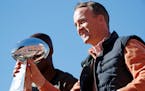 Denver Broncos quarterback Peyton Manning holds the Lombardi Trophy during a parade for the NFL football Super Bowl champions, Tuesday, Feb. 9, 2016, 