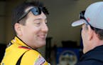 Kyle Busch, left, talked to a crew member during practice for Sunday's Daytona 500.