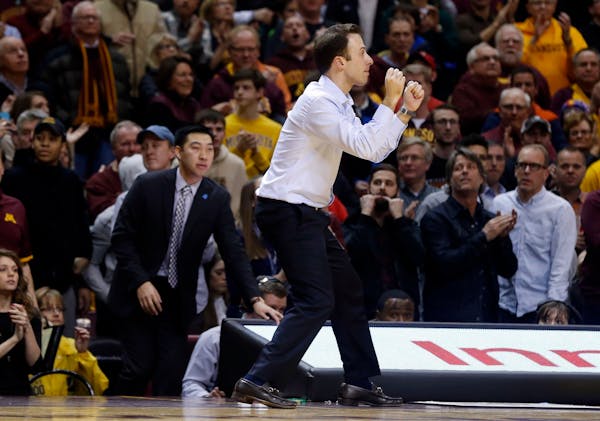 Minnesota head coach Richard Pitino celebrates in the final seconds as his team beat Maryland 68-63 in an NCAA college basketball game Thursday, Feb. 