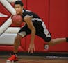 At Patrick Henry H.S., in a game between Holy Family and Minnehaha Academy, Jalen Suggs(1), an eighth grader runs the point for his Minnehaha.] rtsong