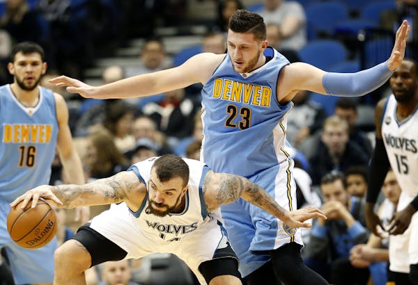 Timberwolves Nikola Pekovic (14) was defended by Jusuf Nurkic (23) in the fourth quarter.