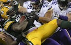 Packers running back Eddie Lacy lost 2 yards on a run in the second quarter, stacked up by outside linebacker Anthony Barr (55) and several other Viki