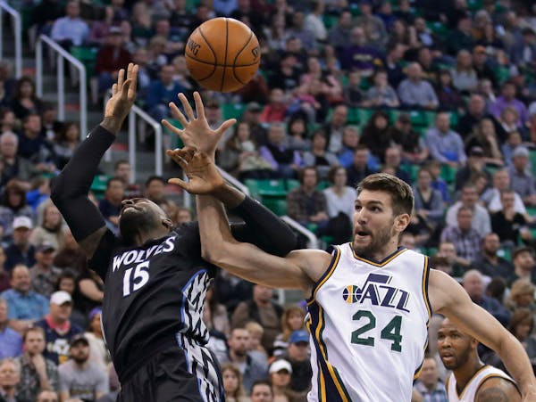 Minnesota Timberwolves forward Shabazz Muhammad (15) and Utah Jazz center Jeff Withey (24) compete for a rebound during the second quarter of an NBA b