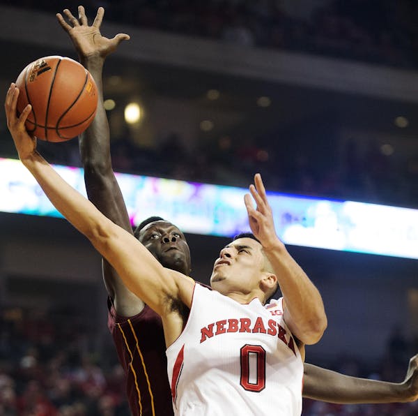 Nebraska guard Tai Webster drove to the basket against Gophers guard Kevin Dorsey during the first half. Webster scored nine points.