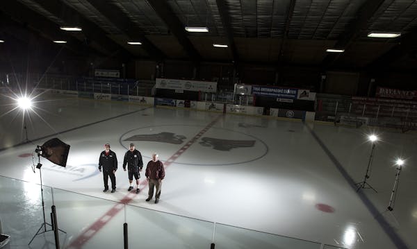 Former coaches Jake McCoy, Larry Hendrickson and Mike Thomas posed for a photo inside an empty Richfield Ice Arena.