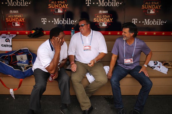 Former Twins Kent Hrbek, and Rick Aguilera, right, reacted to a story told by Dave Winfield as they relaxed in the dugout before the Futures Game Sund