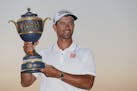 Adam Scott of Australia, holds the Gene Sarazen Cup after winning the Cadillac Championship golf tournament, Sunday, March 6, 2016, in Doral, Fla. (AP