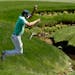Jordan Spieth jumps over a creek on the 13th fairway during a practice round for the Masters golf tournament, Monday, April 4, 2016, in Augusta, Ga. (