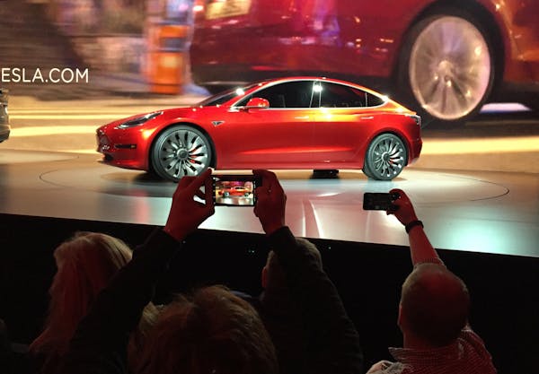 Tesla Motors unveils the new lower-priced Model 3 sedan at the Tesla Motors design studio in Hawthorne, Calif., Thursday, March 31, 2016. It doesn't g