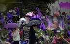 Fans braved the rain and 40-degree temperatures Thursday to visit the Prince memorial at Paisley Park in Chanhassen.