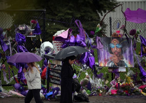 Fans braved the rain and 40-degree temperatures Thursday to visit the Prince memorial at Paisley Park in Chanhassen.