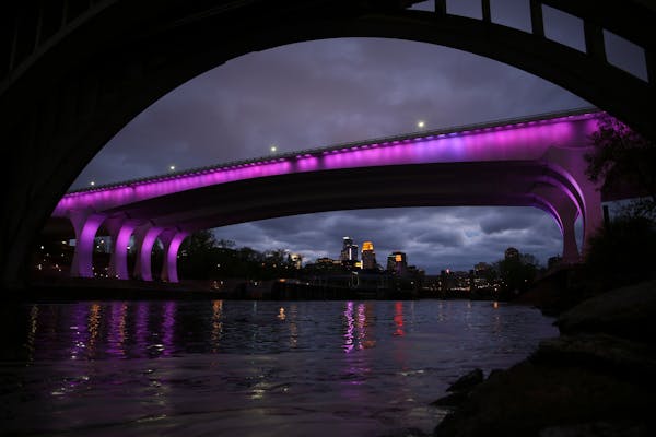 The I-35W bridge was bathed in purple Thursday night in a memorial to Prince.