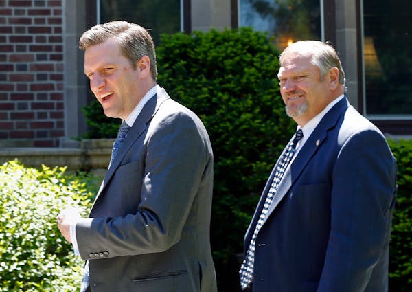 Republican House Speaker Kurt Daudt, left, and Senate Majority Leader Tom Bakk smile at reporters as they arrive at the governor's residence earlier t
