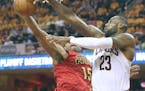 Cleveland Cavaliers' LeBron James looks to pass around Atlanta Hawks' Al Horford during the second quarter on Monday, May 2, 2016, at Quicken Loans Ar