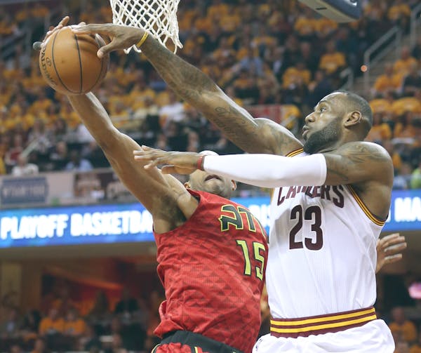 Cleveland Cavaliers' LeBron James looks to pass around Atlanta Hawks' Al Horford during the second quarter on Monday, May 2, 2016, at Quicken Loans Ar