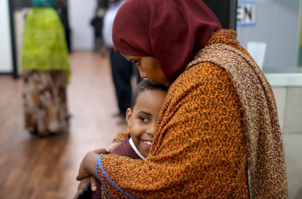 Ayan Farah, the mother of defendant Mohamed Farah, 22, hugged her youngest son Abdirahmin, 9, outside the family's restaurant Friday after Mohamed Far