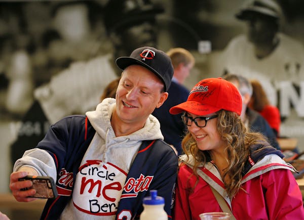 Twins fans Edward Listiko left and Jasmin Hass gathered in Legends Club at Target Field to watched there team open the season against the Detroit Tige