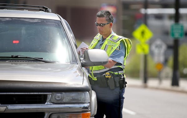 Near the site where a woman was killed in March, a St. Paul police officer issued a traffic citation after a driver did not stop for a pedestrian on T