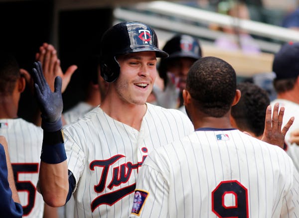 Minnesota Twins Max Kepler is congratulated in the dugout after his three run home run in the fifth inning against the Texas Rangers during a baseball