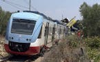 A view of the scene of a train accident after two commuter trains collided head-on near the town of Andria, in the southern region of Puglia, killing 