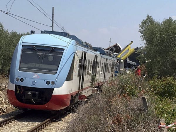 A view of the scene of a train accident after two commuter trains collided head-on near the town of Andria, in the southern region of Puglia, killing 
