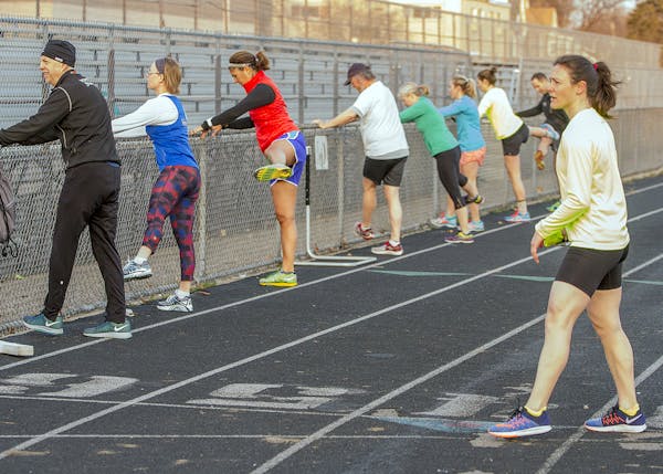 Nicole Cueno, right, coached athletes during a track workout.