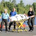 A camper is attended to by ambulance staff after arriving Thursday, July 21, 2016 in Ely, Minn., by floatplane from the Boundary Waters Canoe Area Wil