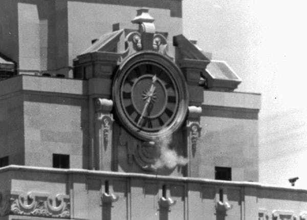 In this Aug. 1, 1966 file photo, smoke rises from the sniper's gun as he fired from the tower of the University of Texas administration building in Au